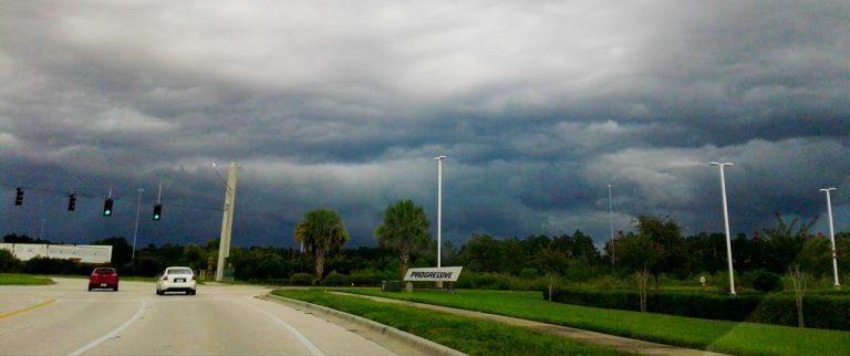 cars driving into a storm