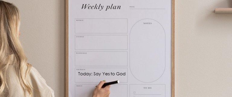 young adult woman marking up a weekly planner that says "Today: Say Yes to God"