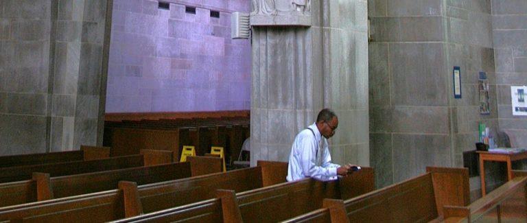 a man praying alone in church