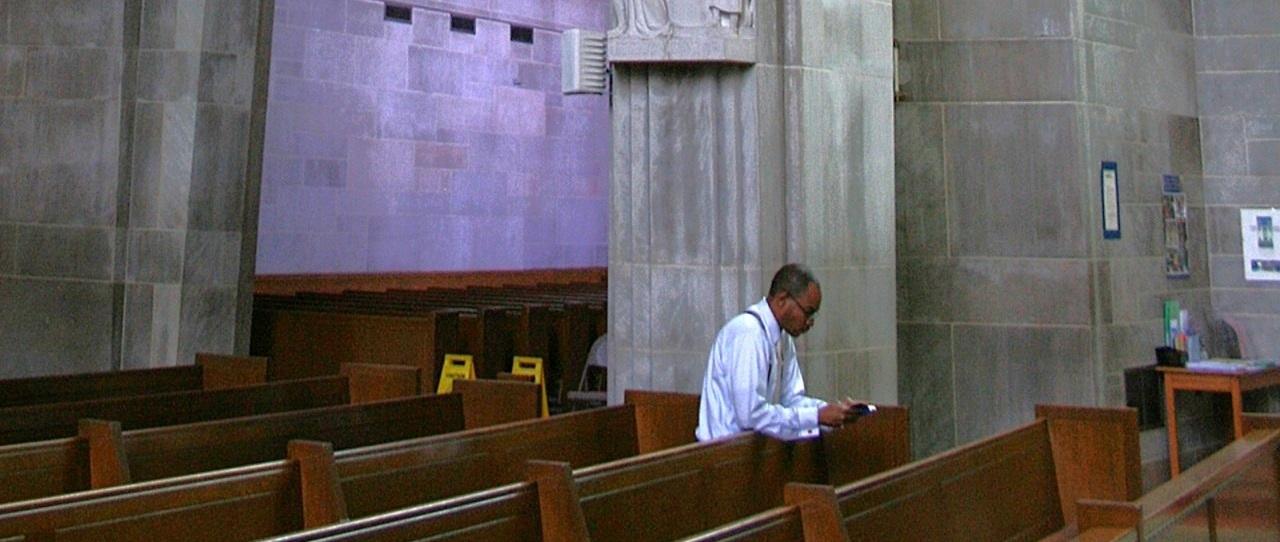 a man praying alone in church